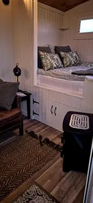 a room with a bed with a window and a couch at North Muasdale Farm, Ewe View in Muasdale
