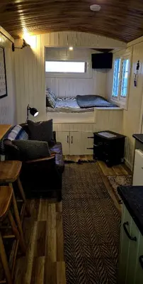 a room with a bed and a couch and a table at North Muasdale Farm, Ewe View in Muasdale