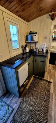 a kitchen with a black counter top and a sink at North Muasdale Farm, Ewe View in Muasdale