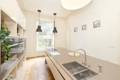 a kitchen with a sink and a counter at JOIVY Exclusive house with free parking in Edinburgh