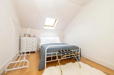 a small bedroom with a bed and a dresser at JOIVY Exclusive house with free parking in Edinburgh