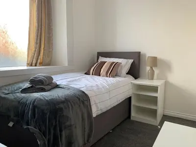 a bedroom with a bed and a window at High Street 2 Bedroom Apartment in Ayr