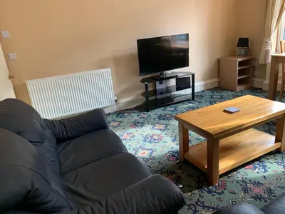 a living room with a couch and a coffee table at High Street 2 Bedroom Apartment in Ayr