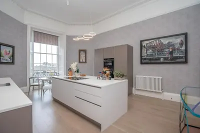a kitchen with a white island in a room at Georgian Gem in the New Town in Edinburgh