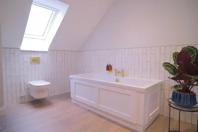 a white bathroom with a sink and a toilet at Lowwood Lodges in Houston