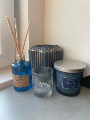 a table with a candle and a container with chopsticks at Foundry Street Apartment 2 - Dunfermline city centre in Dunfermline