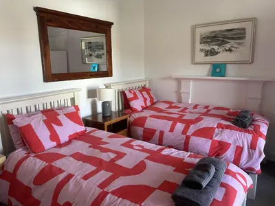 two beds sitting next to each other in a bedroom at Unique house in an idyllic situation on a beach in Port Ellen