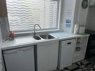 a kitchen counter with a sink and a window at Unique house in an idyllic situation on a beach in Port Ellen