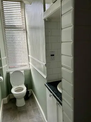 a small bathroom with a toilet and a sink at West Dunbartonshire Flat, near Loch Lomond in Dumbarton