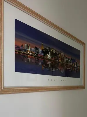 a framed picture of a painting of a city at West Dunbartonshire Flat, near Loch Lomond in Dumbarton