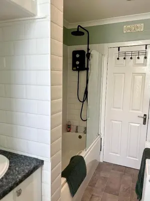 a bathroom with a shower and a white door at West Dunbartonshire Flat, near Loch Lomond in Dumbarton
