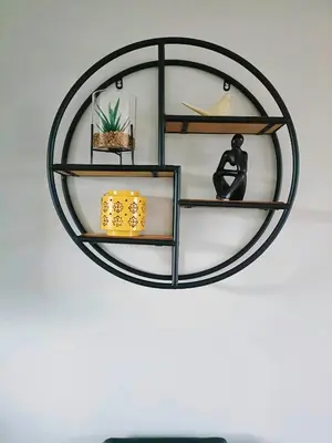 a circular shelf on a wall with a black at Largs Seaside Loft 2 R in Largs