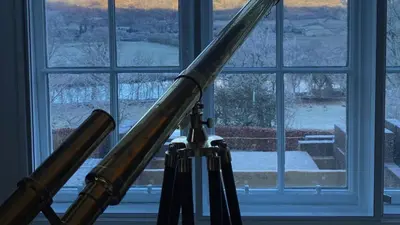 a pair of telescopes in front of a window at Beautiful House With Gardens Close To River Tay in Remony