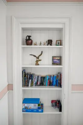 a white book shelf filled with books at Oban Bay Views - Fireplace, Games & Books in Oban