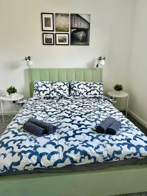 a bedroom with a bed with two pillows on it at ClydeBank Brand new 3BDR Home, Glasgow in Clydebank