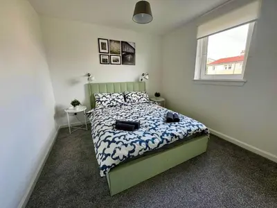 a bedroom with a bed and a window at ClydeBank Brand new 3BDR Home, Glasgow in Clydebank