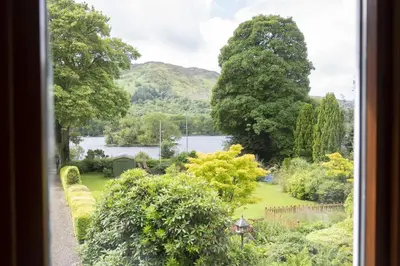 a view of a garden from a window at The Coach House in Saint Fillans
