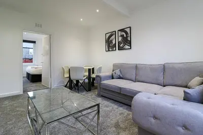 a living room with a couch and a table at Marchfield Promenade View in Prestwick