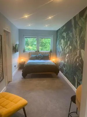 a bedroom with a bed and a large window at House Aurora in Edinburgh