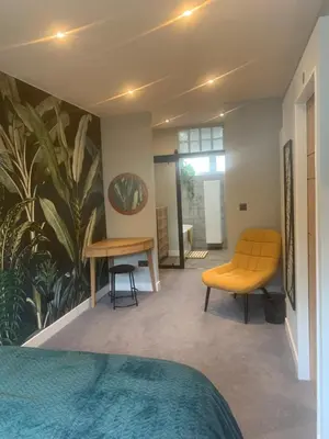 a bedroom with a bed and a table and chairs at House Aurora in Edinburgh