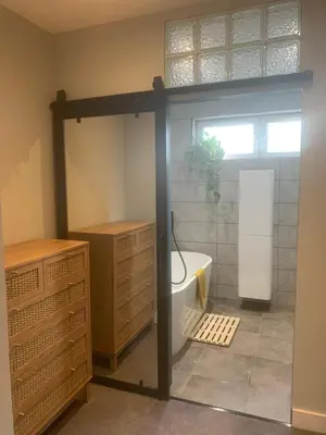a bathroom with a bath tub and a sink at House Aurora in Edinburgh