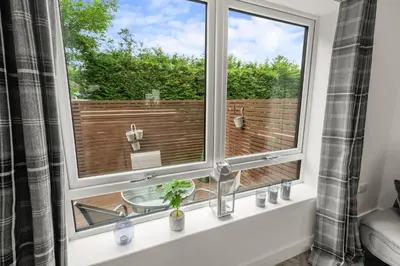 a bathroom with a window with a view of a deck at Beautiful 1 BR apt with private patio and free parking in Dunollie