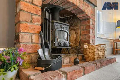 a brick fireplace with a stove in a room at Albert Road in Gourock