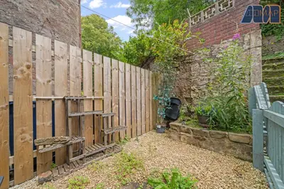a wooden fence next to a brick wall at Albert Road in Gourock