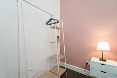a room with a glass wall with a shelf at 4 Beds - City Gateway Getaway with Free Parking in Glasgow