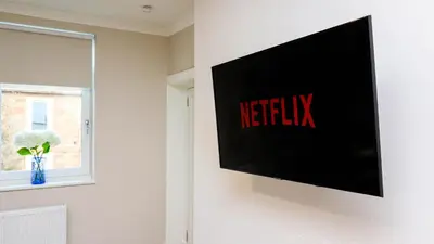 a flat screen tv hanging on a wall at Modern And Cozy Apex Apartment in Helensburgh