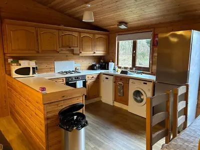 a kitchen with a refrigerator and a dishwasher at Lomond View Lodge in Glasgow