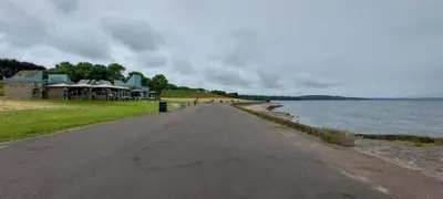 an empty road next to a body of water at Comfortable Double Room, Great Transport to City Centre and Airport, 5 mins to Beach, Great Value in Edinburgh