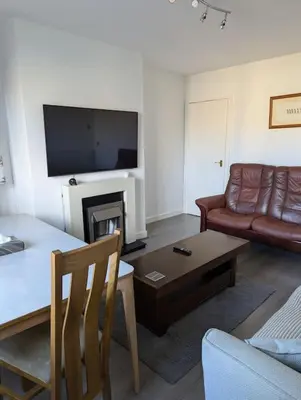 a living room with a couch and a table at Lovely 3-Bed Edinburgh Flat in Edinburgh