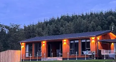 a house with orange lights on the side of it at Arrochar View in Langbank
