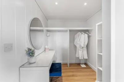 a dressing room with a mirror and a dressing table at Arrochar View in Langbank