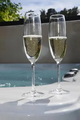 two glasses of white wine sitting on a table at Argyll View in Langbank
