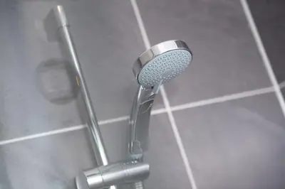 a shower with a shower head in a bathroom at Argyll View in Langbank