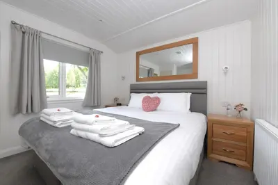 a bedroom with a bed with towels on it at Argyll View in Langbank