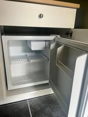 an empty refrigerator with its door open in a kitchen at Kirkton Rest in Cardross