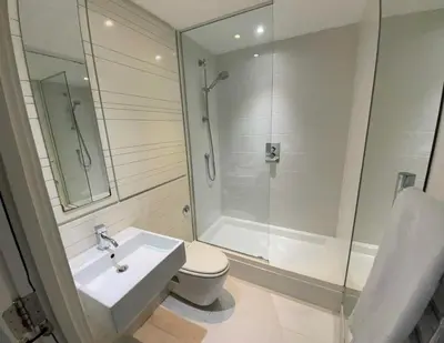 a bathroom with a shower and a toilet and a sink at Glasgow Harbour River West End in Glasgow