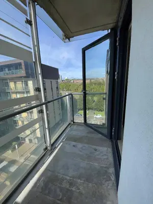 an empty balcony with a view of a building at Glasgow Harbour River West End in Glasgow