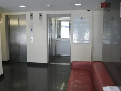 a waiting room with a red couch in a building at Glasgow Harbour River West End in Glasgow