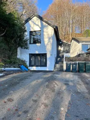 a white house sitting on the side of a road at Craig Chat in Oban