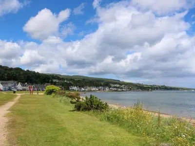 a grassy field next to a body of water at Lodge 1 