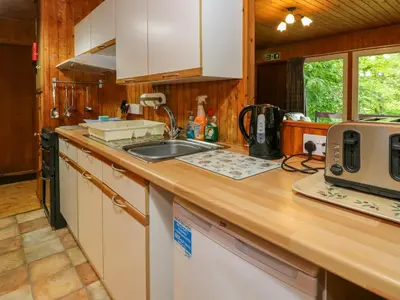a kitchen counter with a sink and a microwave at Lodge 3 - 