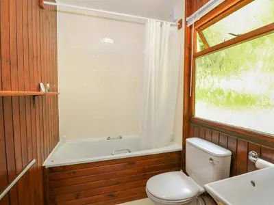 a bathroom with a tub and a toilet and a sink at Lodge 6 - 