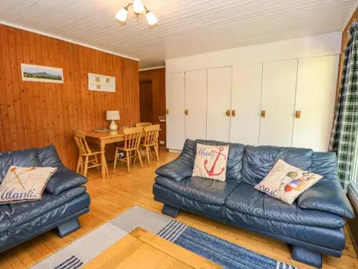 a living room with a leather couch and a table at Lodge 6 - 