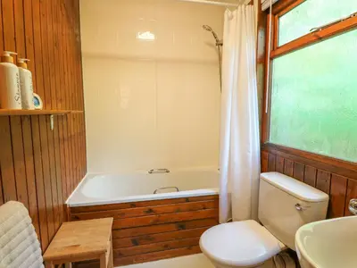 a bathroom with a tub and a toilet and a sink at Lodge 4 - 