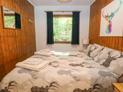 a bedroom with a bed with towels on it at Lodge 4 - 