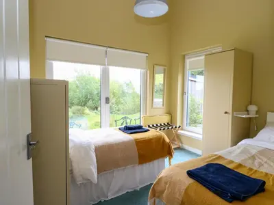 a bedroom with two beds and a window at Tirlaggan House in Oban